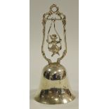 A German silver novelty table bell, the handle as a young girl in a swing, marked .