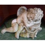 A contemporary composite garden ornament, of a sleeping cherub,