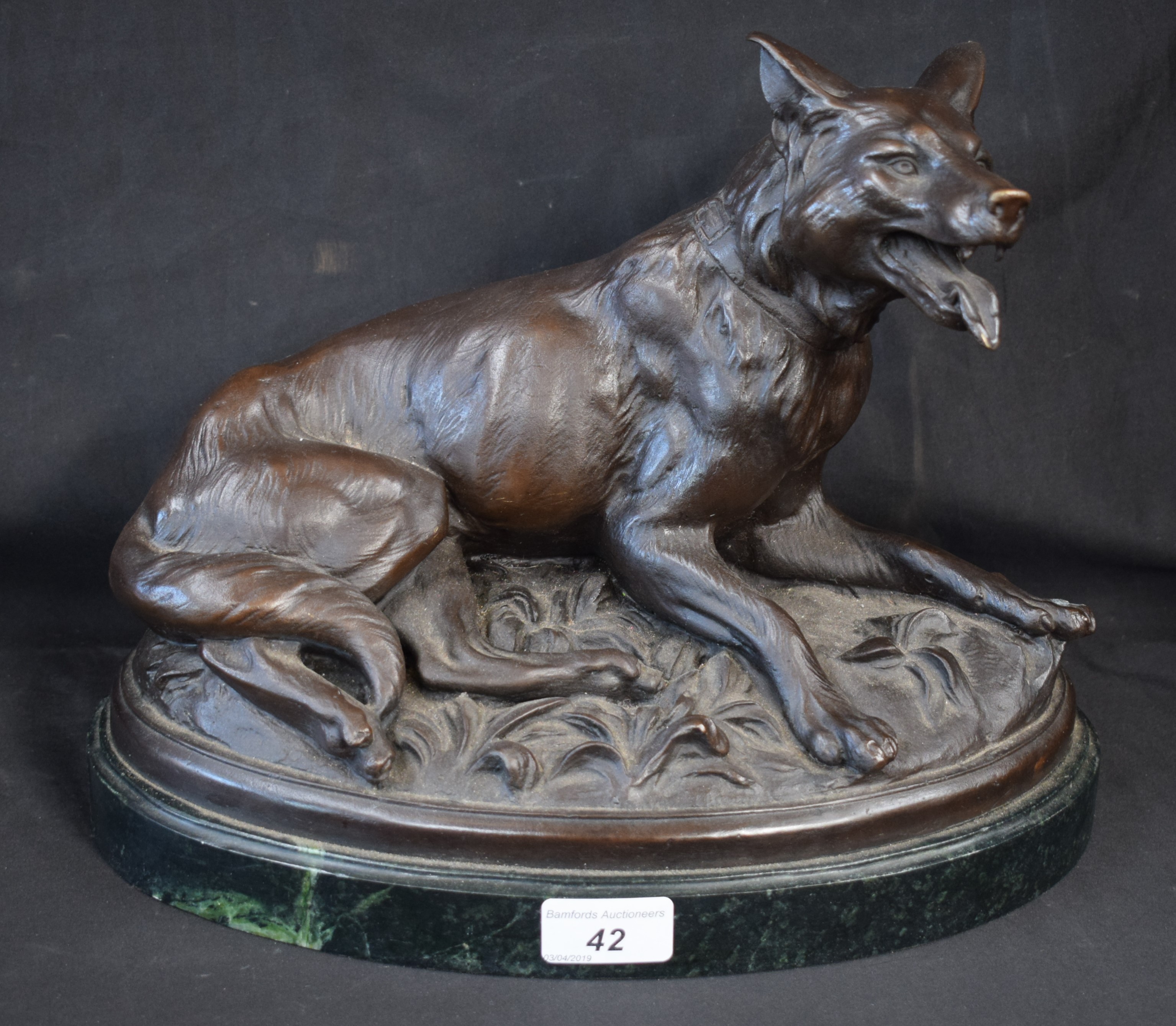 French School, after, a bronzed model, of a hound, oval base, 32.