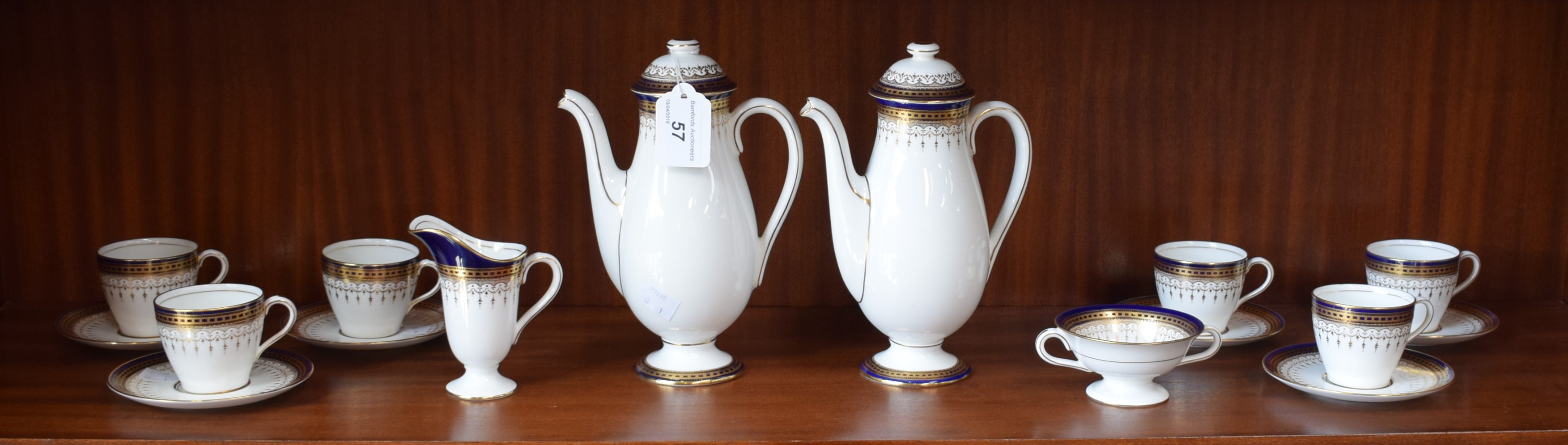 A Royal Doulton six setting coffee service, decorated with cobalt blue and gilt bands,