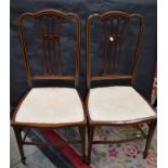 A pair of Edwardian mahogany salon side chairs, serpentine cresting rails, stuffed over seats,