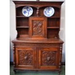 A Flemish style oak dresser, outswept moulded cornice carved with flowerheads,