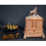 A German Black Forest jewellery box, hinged stag carved cover, above four fold out compartments,