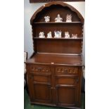 A 20th century oak dining table, rounded rectangular top above a carved deep frieze,