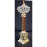 A brass table lamp, as an oil lamp, cut glass reservoir, Corinthian column support,