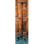 A 20th century mahogany torchère, hipped triform legs,