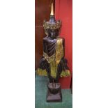 A carved and gilded softwood figural statue, possibly Thai, standing in dress upon a pedestal,