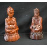 Tribal Art - a pair of carved wooden figures, Emperor and Empress, seated cross legged,