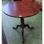 A George III mahogany occasional table, circular one-piece tilting top, turned column,