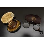 A pair of tortoiseshell effect folding spectacles, round lenses, folding arms and bridge,