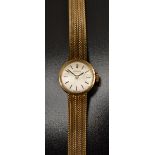 Longines - a retro 1970s lady's 9ct gold bracelet watch, silvered dial, block batons,