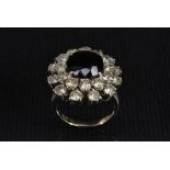 An 18ct gold sapphire and diamond cluster ring,