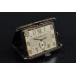 An Art Deco Borel Fils & Cie purse watch, modelled as a rectangular leather covered suitcase,