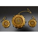 A Victorian diamond inset gold coloured metal demi parure three piece target brooch and earrings,