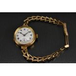 Visible - a vintage 1920s 9ct gold bracelet watch, enamel dial, black Roman numerals with blue XII,