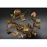 A 9ct gold charm bracelet, suspending fifteen various charms, another detached, inc House, Mouse,