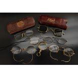 Spectacles - a pair of vintage gilt metal framed oval spectacles, clear nose pads,