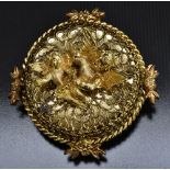 A retro Reuge Ste Croix clockwork music box brooch, gilt metal body with two Cherubs,