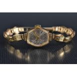 A 9ct gold Everite lady's wristwatch, shaped hexagonal silvered dial, block baton markers,