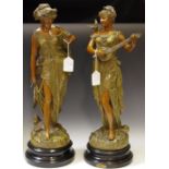 A pair of Art Nouveau style French spelter figures applied with plaques inscribed 'Duo' and