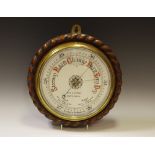A Victorian oak cased Aneroid barometer, the 19cm circular porcelain dial inscribed W S Garson,