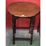 A 20th century oak occasional table, shaped circular top, spirally turned supports,