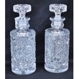 A pair of heavy cut crystal cylindrical decanters,