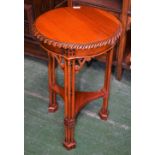 A reproduction mahogany occasional table, circular top, incurved triangular undertier,