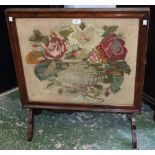 An early 20th century mahogany framed fire screen, adjustable rectangular glazed panel,