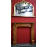 A contemporary pine fire surround, 122cm wide; a contemporary gilt framed overmantel mirror,