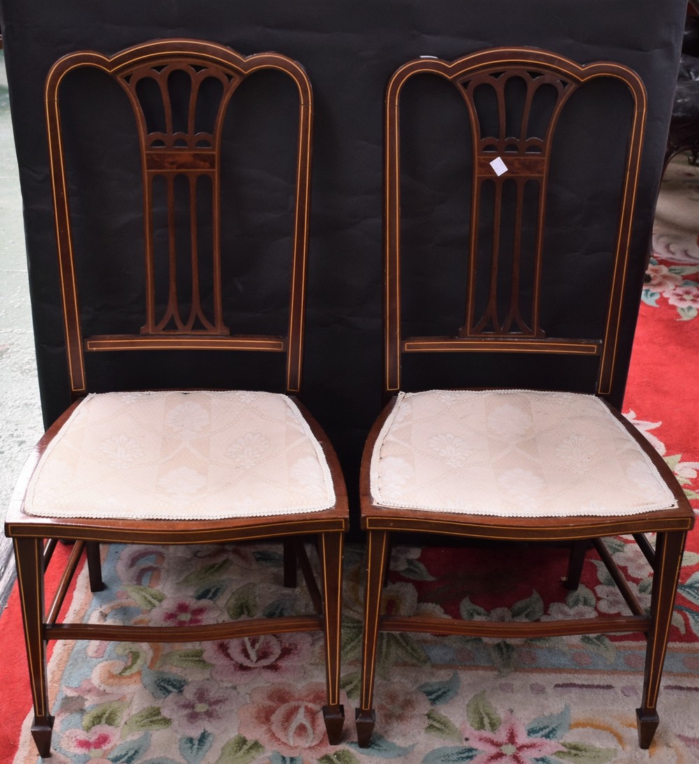 A pair of Edwardian mahogany salon side chairs, serpentine cresting rails, stuffed over seats,