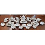 A floral pattern gilt edged dinner service, including dinner plates, side plates,