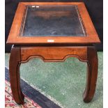 A Chinese inspired coffee table, rectangular top with inset bevelled glass panel, shaped apron,