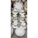 A Royal Albert part tea service, painted with Violets and foliage, green band, comprising cups,