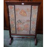 An early 20th century oak framed tall fire screen, inset Heraldic tapestry panel,