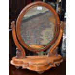 A 19th century mahogany dressing mirror, oval plate flanked by scrolling supports,