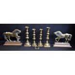 A pair of brass fireside horses; a pair of 19th century brass candlesticks;