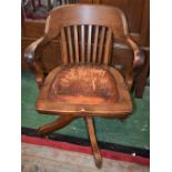 An early 20th century oak swivel desk chair