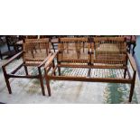 A Danish teak two seat sofa; a conforming armchair, each with woven cane backs,