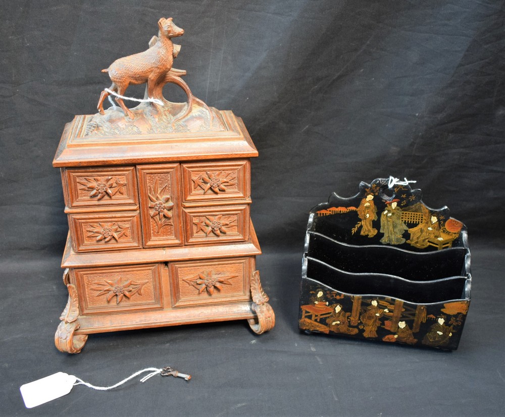A German Black Forest jewellery box, hinged stag carved cover, above four fold out compartments,