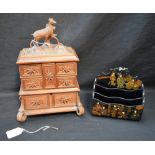 A German Black Forest jewellery box, hinged stag carved cover, above four fold out compartments,