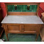 An early 20th century oak washstand, tiled half gallery back,