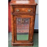 An early 20th century walnut and mahogany music cabinet,