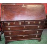 A 19th century mahogany bureau, fall front enclosing an inset writing surface, a small door,