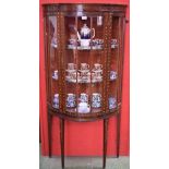 An early 20th century bowed mahogany display cabinet,