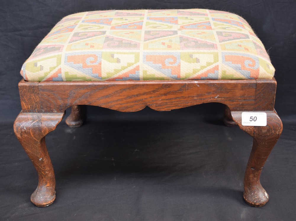 A 20th century oak footstool, cabriole legs, pad feet,