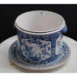 A late 19th/early 20th century Dutch Delft jardiniere and stand, blue and white floral decoration,