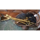 A copper coal scuttle; a set of Victorian brass fire irons;