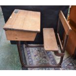 An early 20th century pine school desk, cast metal frame,