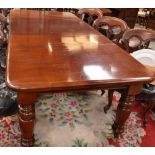 A Victorian style mahogany extending dining table, rounded rectangular top, turned legs,